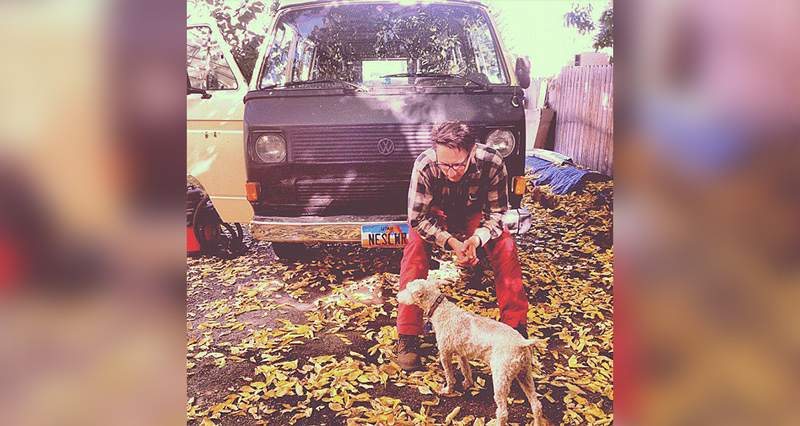 Parcel Account manager sitting on van with dog in fall team