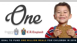 boy smiling holding sandwich next to one initiative logo with england crests