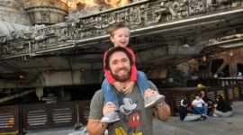 Marketing brand manager holding son smiling in Disneyland employee spotlight