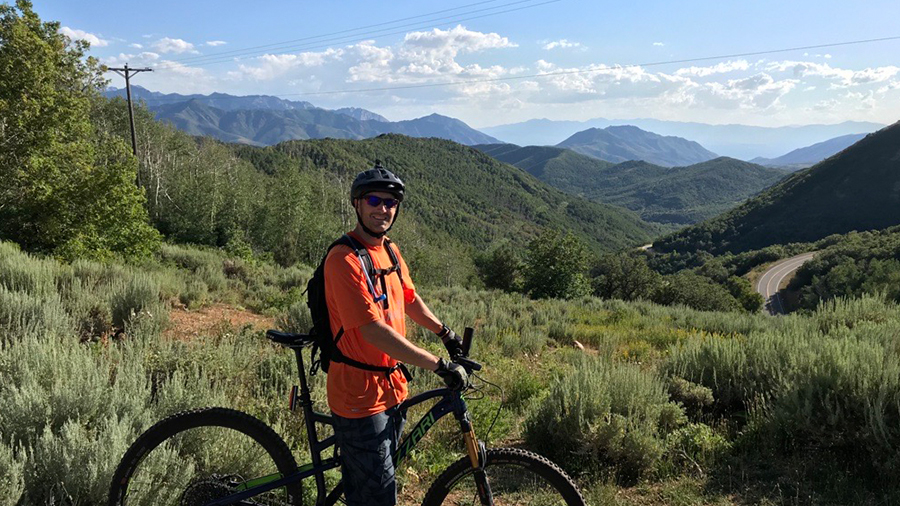 Corporate trainer riding mountain bike in mountains