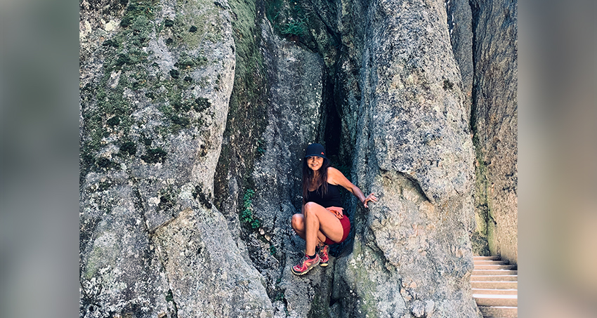 Business coach mountain hiking in rock formation employee spotlight